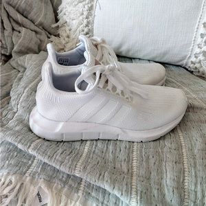 Women’s white Adidas sneakers